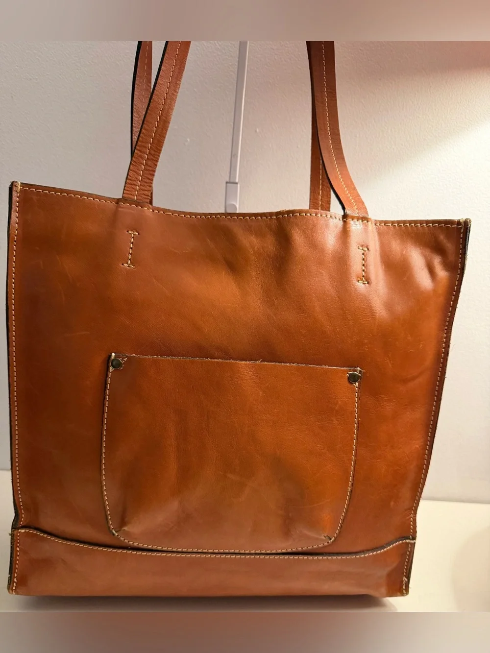 Patricia Nash brown/cognac tote with geometric laser cut pattern.